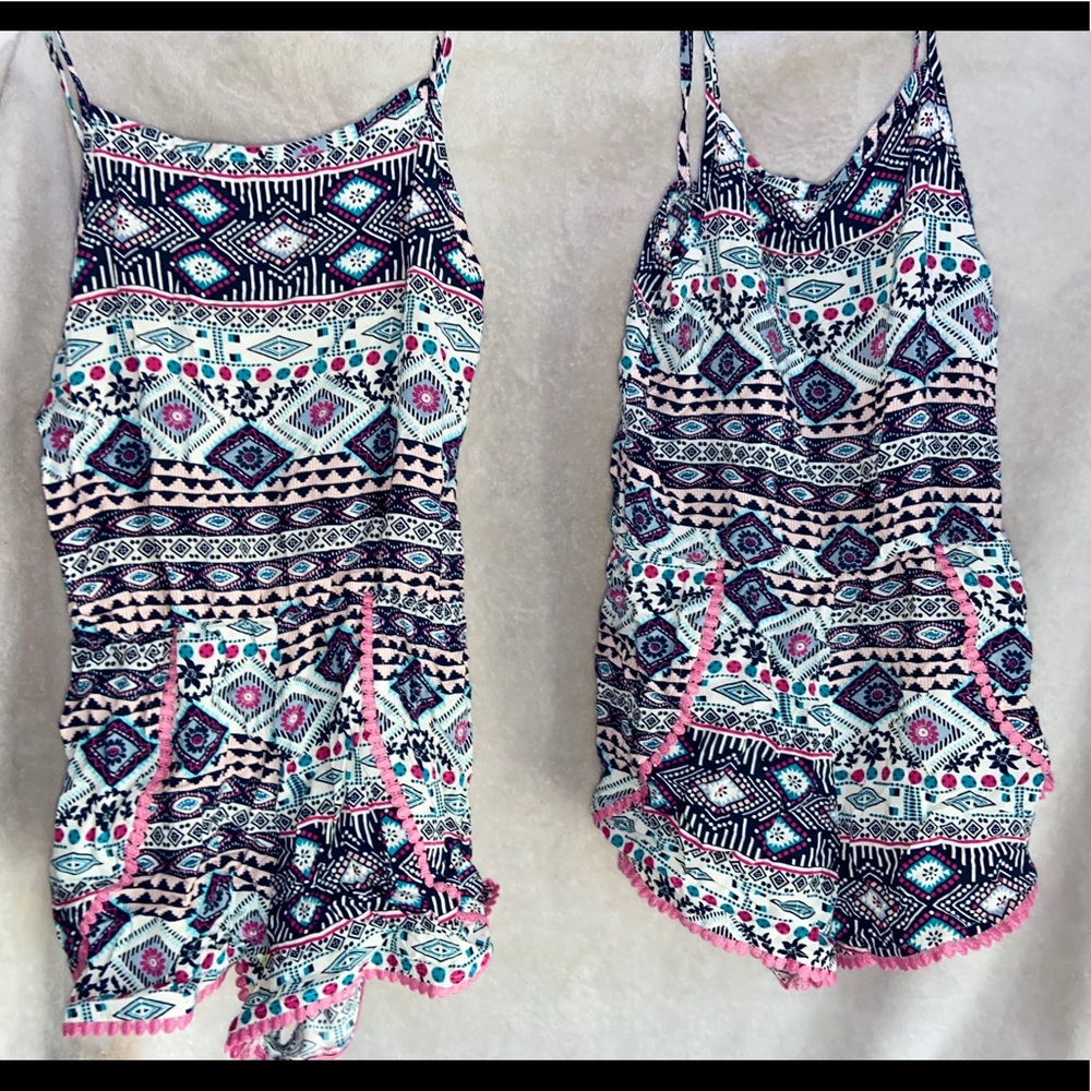 A two pack of multi colored rompers